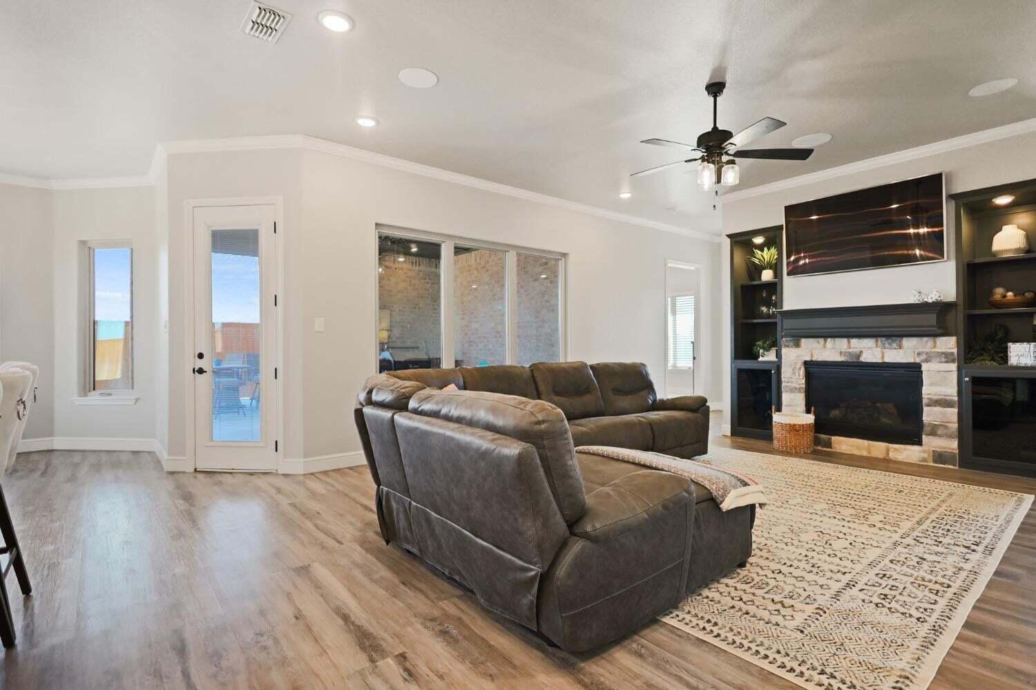 3416 141st Street Lubbock, TX 79423 - Photo 6 of 32 a living room with furniture and a fireplace