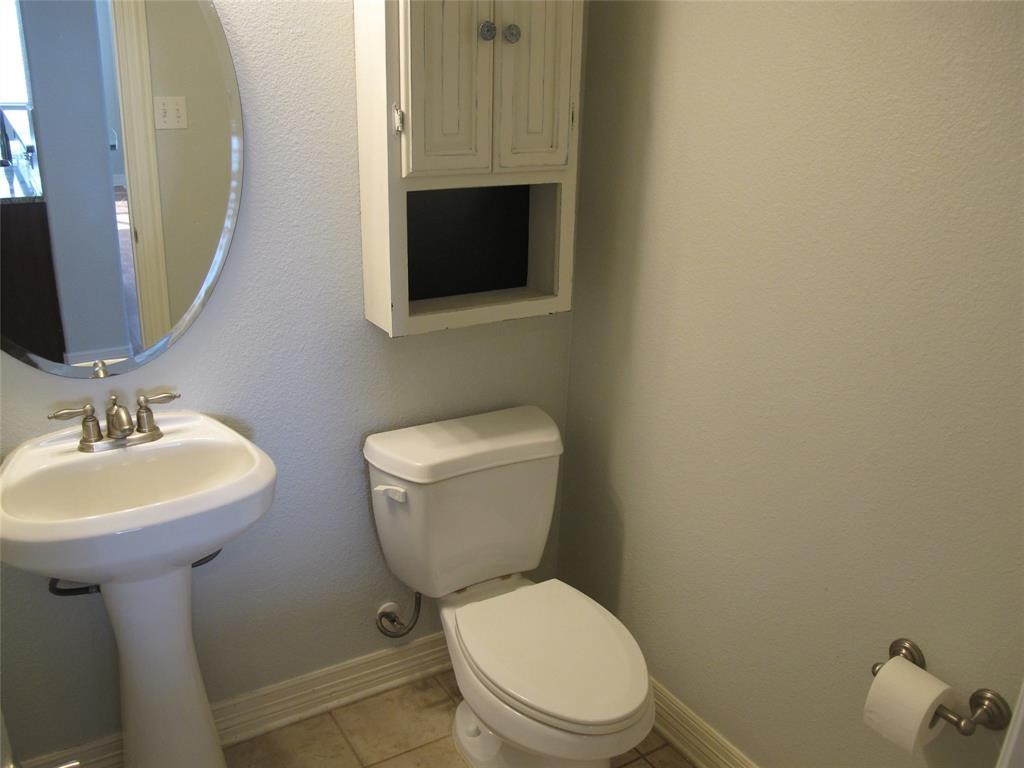 6715 Windrift Way, Unit 15 Austin, TX 78745 - Photo 12 of 37 a bathroom with a toilet a sink and mirror