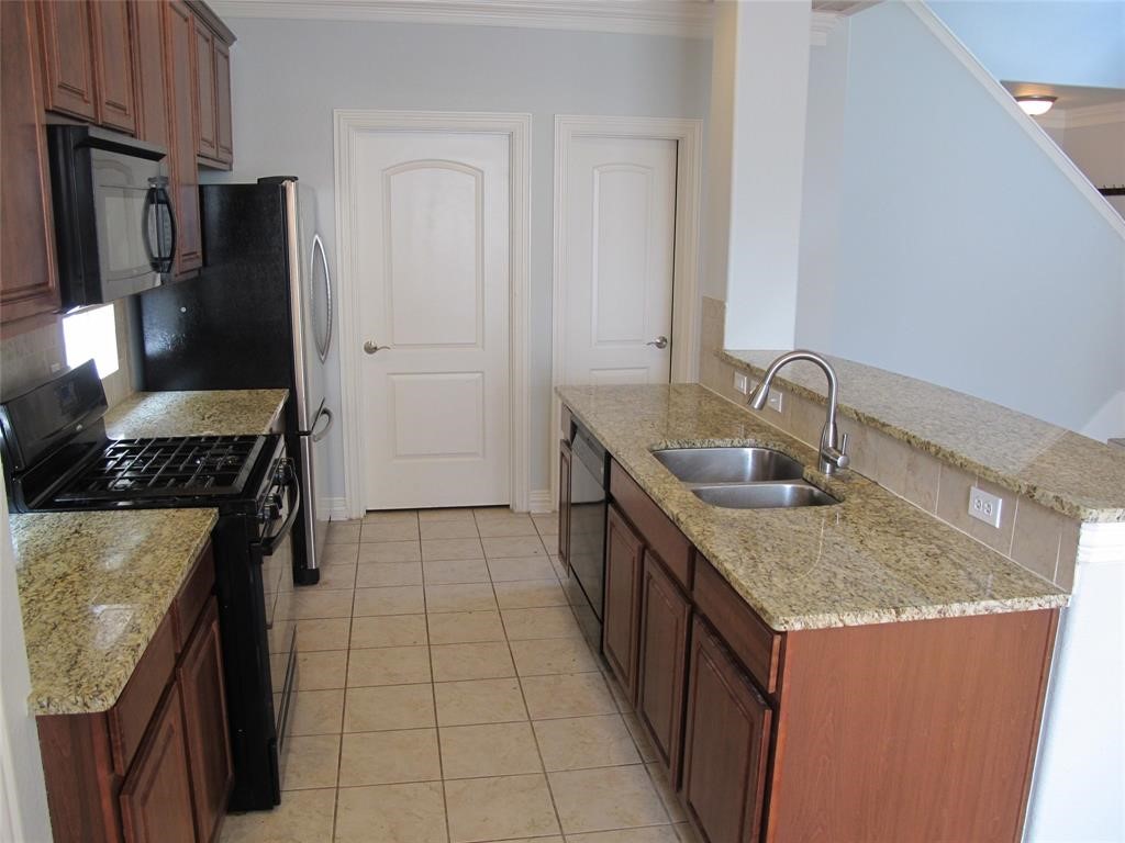 6715 Windrift Way, Unit 15 Austin, TX 78745 - Photo 15 of 37 a kitchen with granite countertop a sink stove and refrigerator
