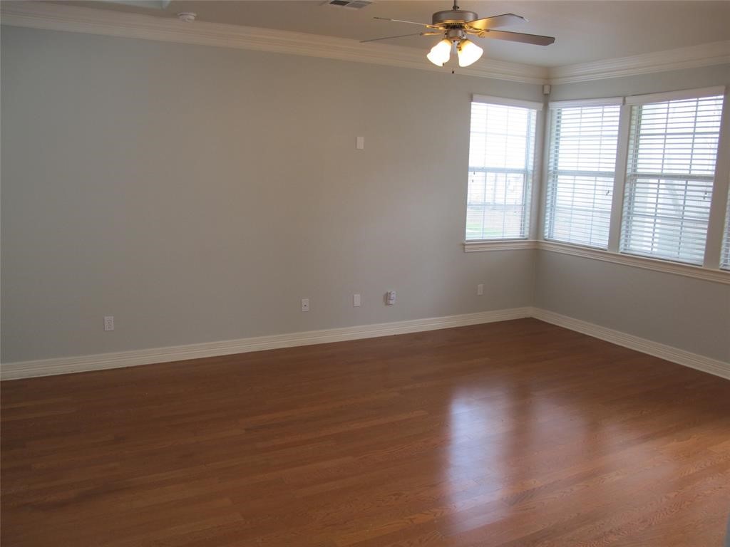 6715 Windrift Way, Unit 15 Austin, TX 78745 - Photo 19 of 37 wooden floor in an empty room with a window