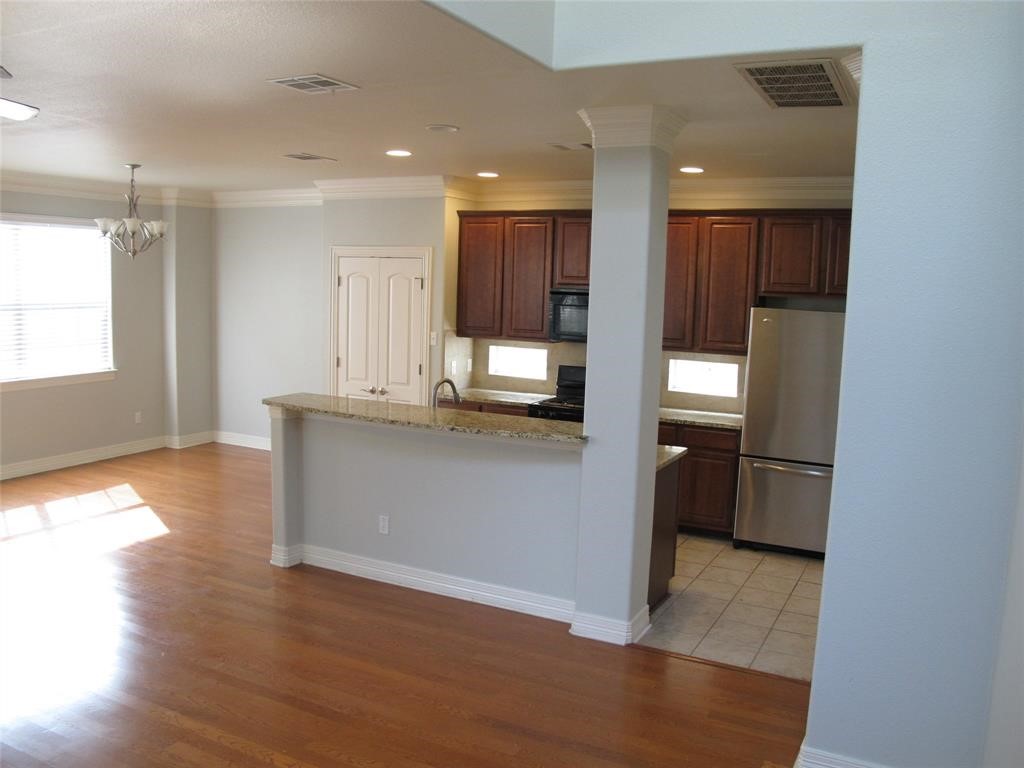6715 Windrift Way, Unit 15 Austin, TX 78745 - Photo 20 of 37 a kitchen with kitchen island granite countertop a refrigerator and a sink