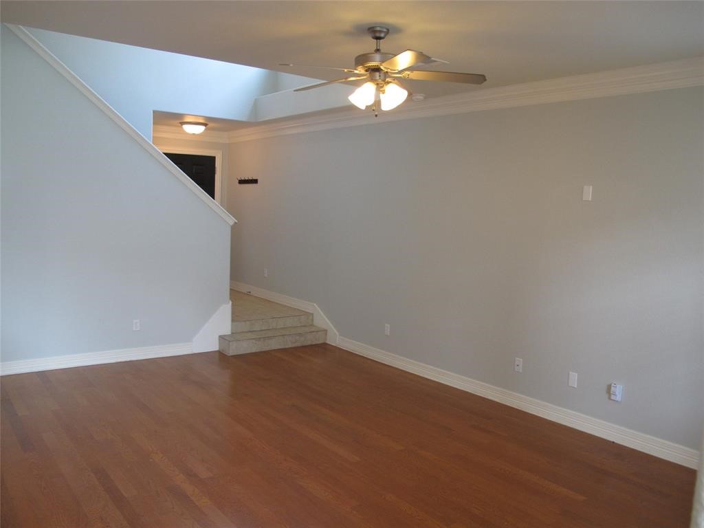 6715 Windrift Way, Unit 15 Austin, TX 78745 - Photo 21 of 37 a view of empty room with wooden floor and ceiling fan