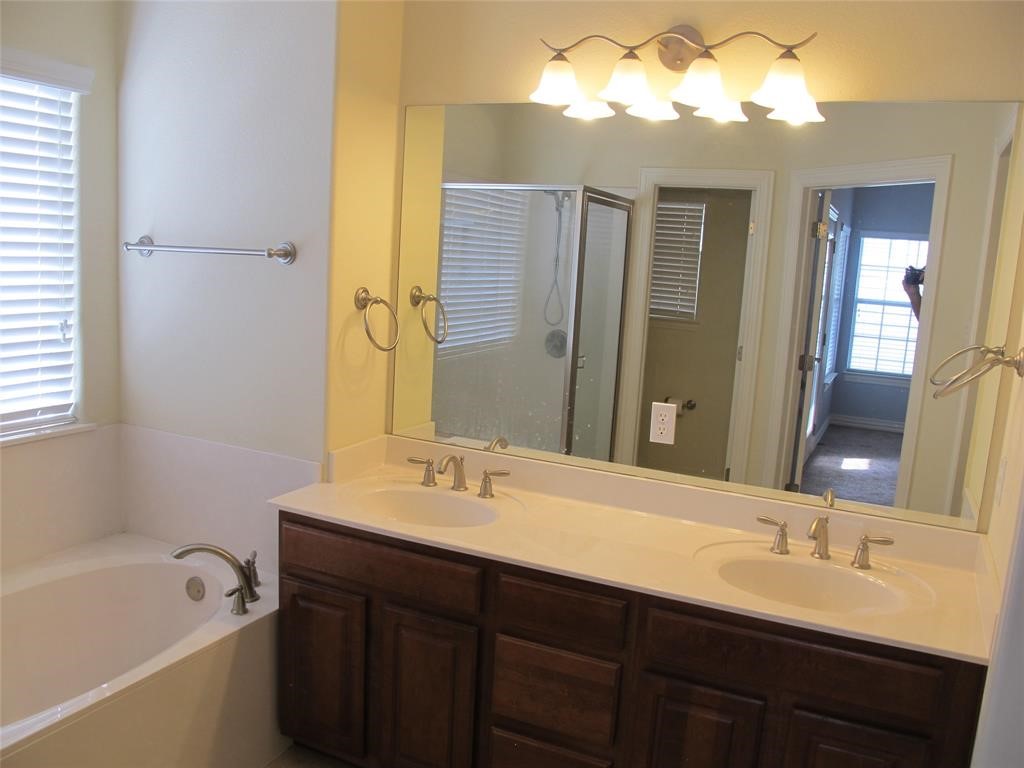 6715 Windrift Way, Unit 15 Austin, TX 78745 - Photo 26 of 37 a bathroom with a double vanity sink mirror double and bathtub