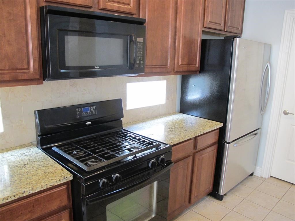 6715 Windrift Way, Unit 15 Austin, TX 78745 - Photo 9 of 37 a stove top oven sitting inside of a kitchen