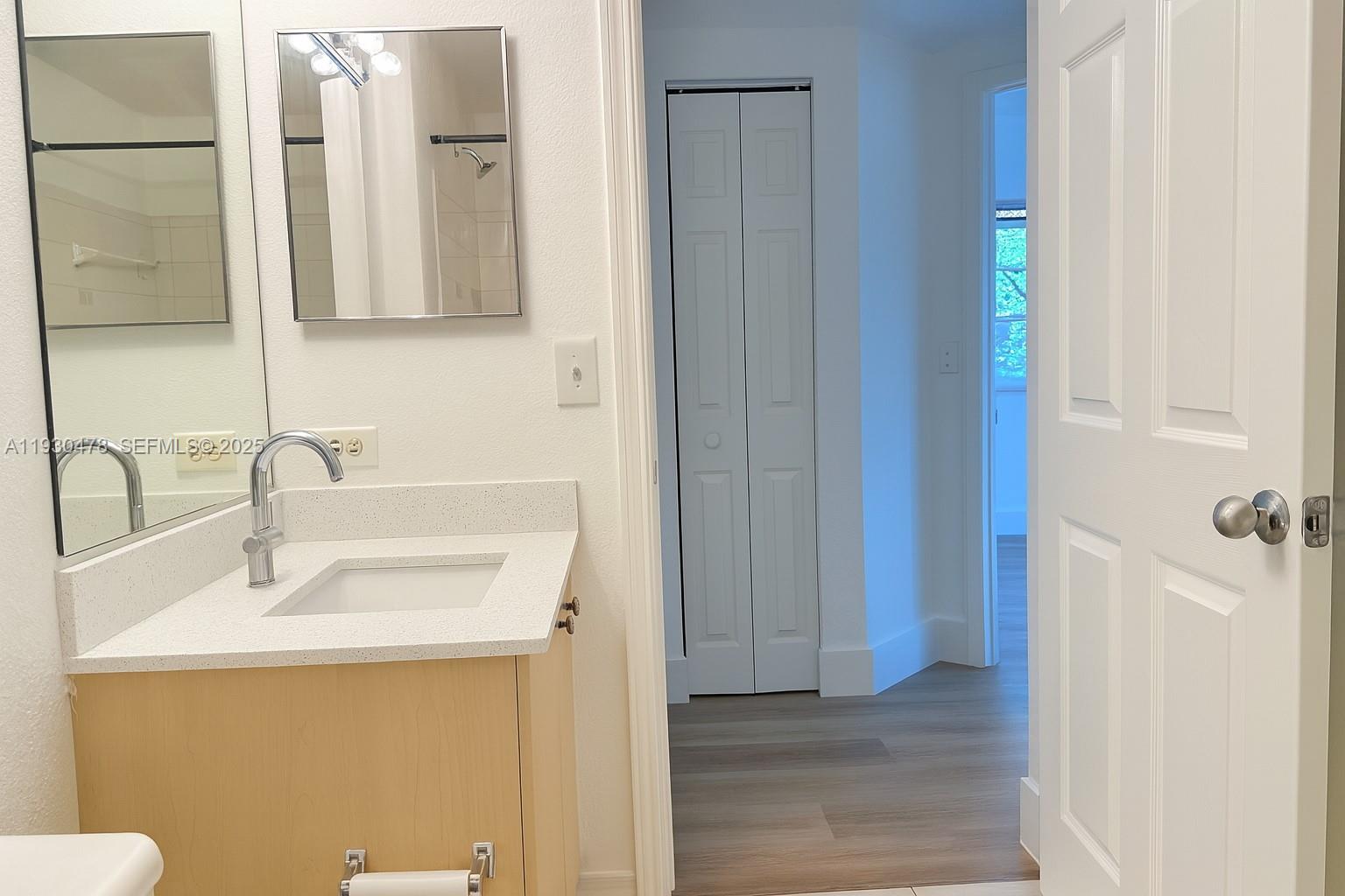 2564 Centergate Drive, Unit 208 Miramar, FL 33025 - Photo 15 of 31 a bathroom with a sink and a mirror