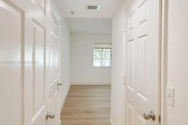 a view of an entryway with wooden floor