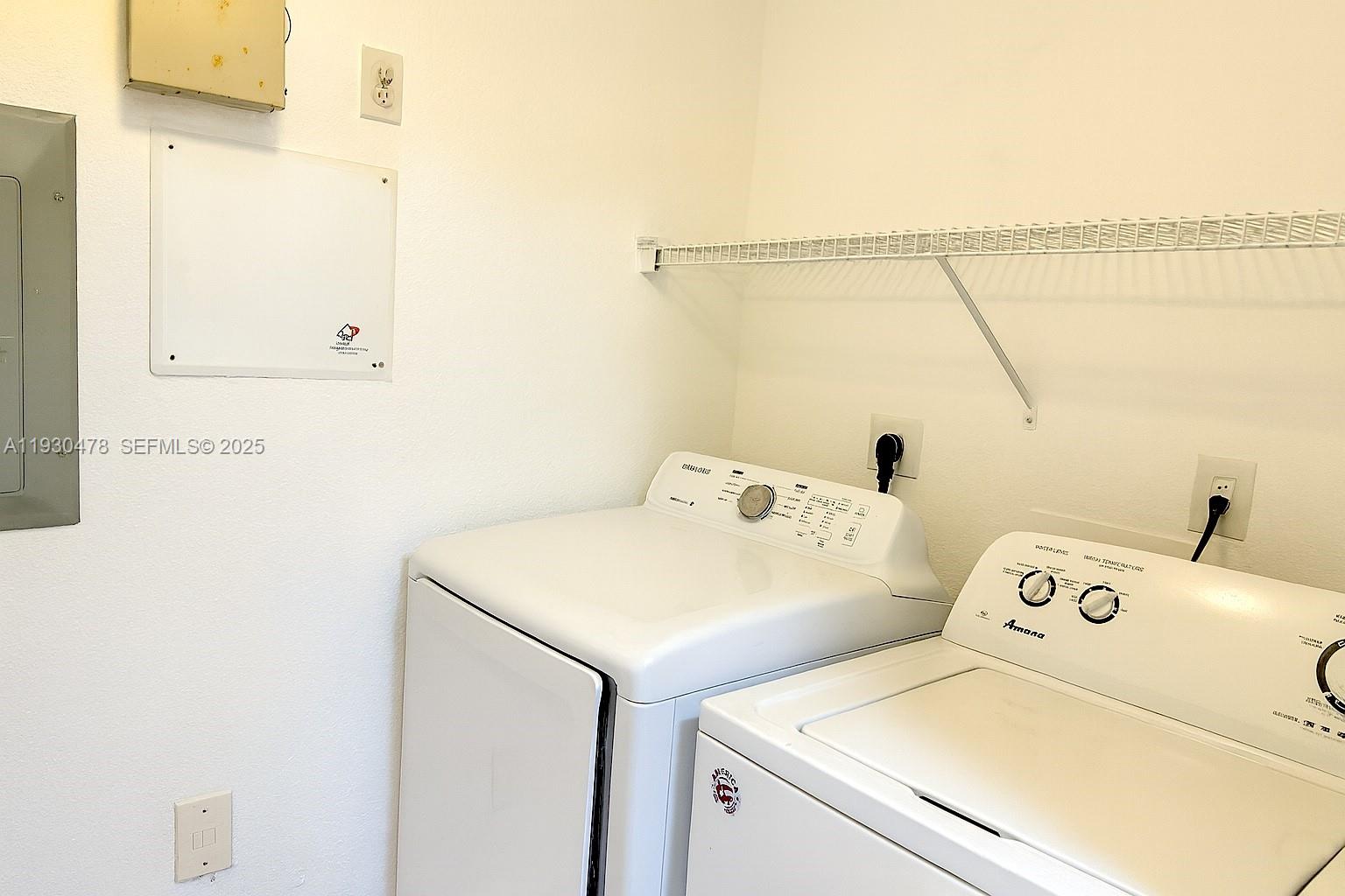 2564 Centergate Drive, Unit 208 Miramar, FL 33025 - Photo 21 of 31 a utility room with dryer and washer