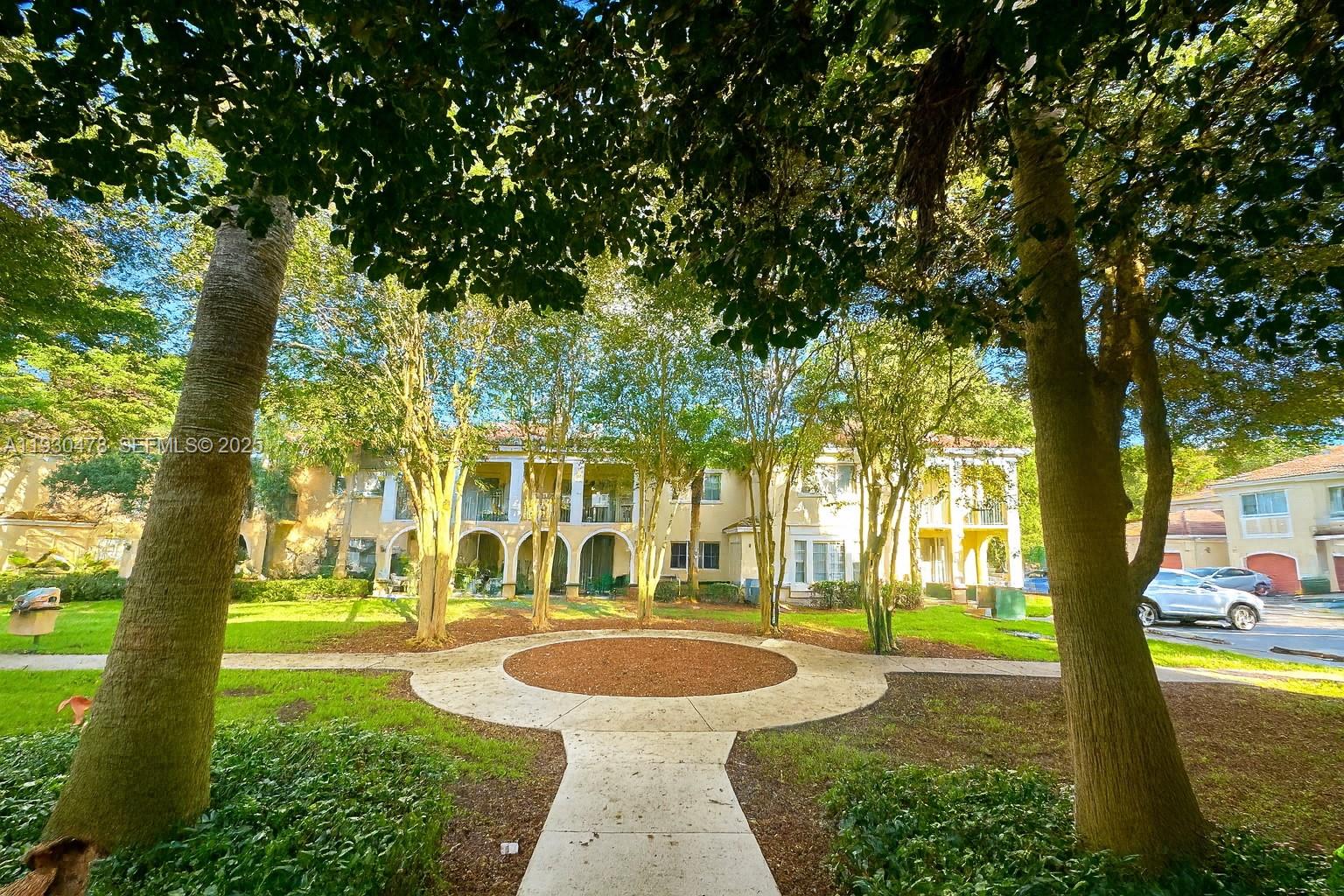 2564 Centergate Drive, Unit 208 Miramar, FL 33025 - Photo 23 of 31 a building with trees in front of it