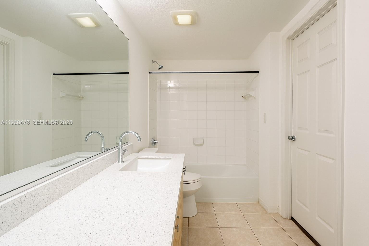 2564 Centergate Drive, Unit 208 Miramar, FL 33025 - Photo 7 of 31 a bathroom with a sink and a mirror