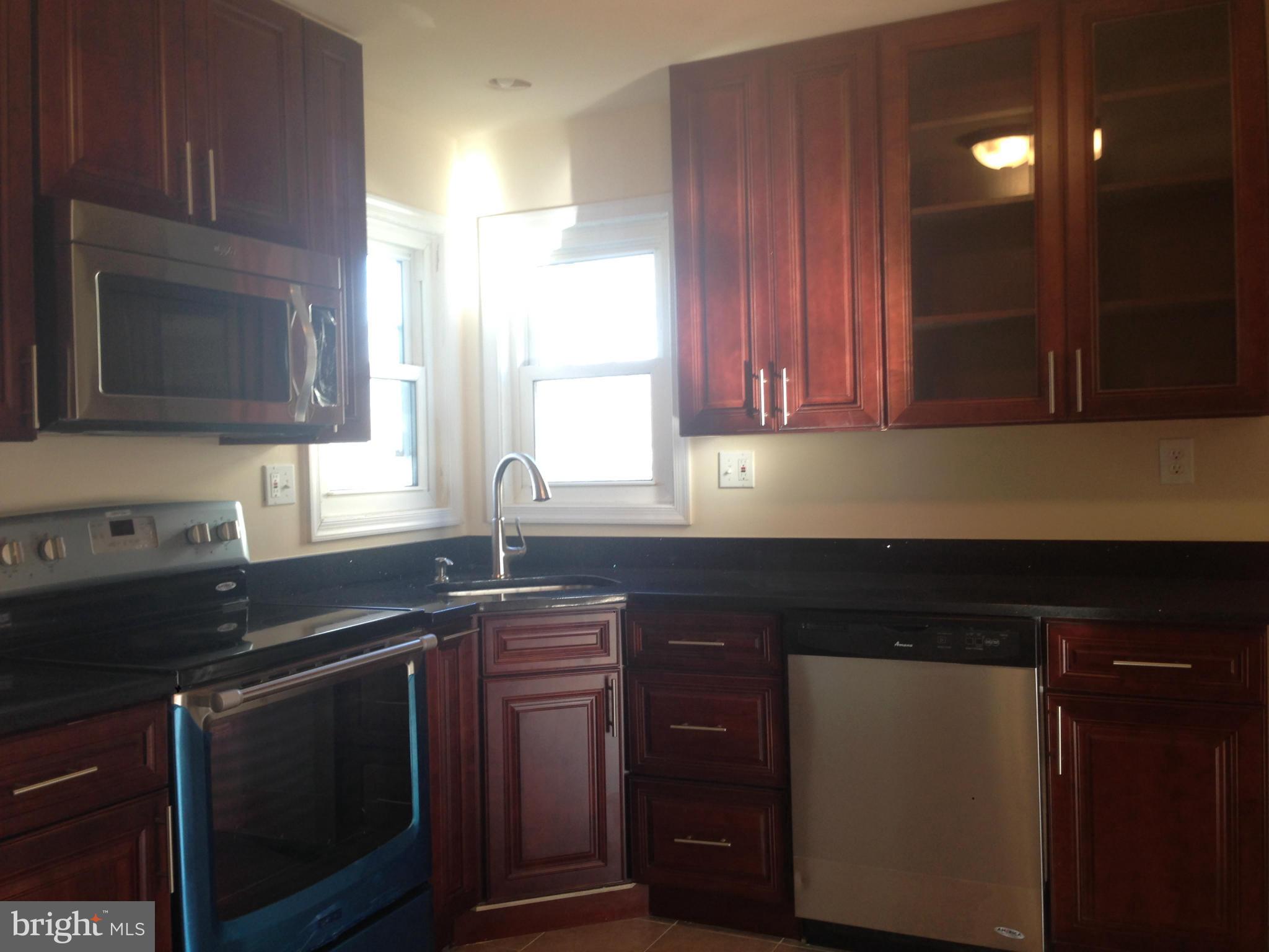 7208 Powhatan Street Lanham, MD 20706 - Photo 2 of 28 a kitchen with granite countertop a sink and a stove