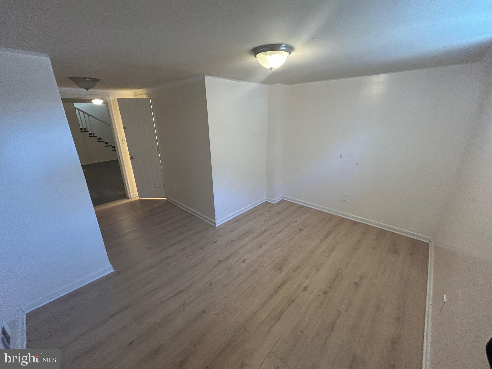 7208 Powhatan Street Lanham, MD 20706 - Photo 21 of 28 a view of hallway with stairs and wooden floor