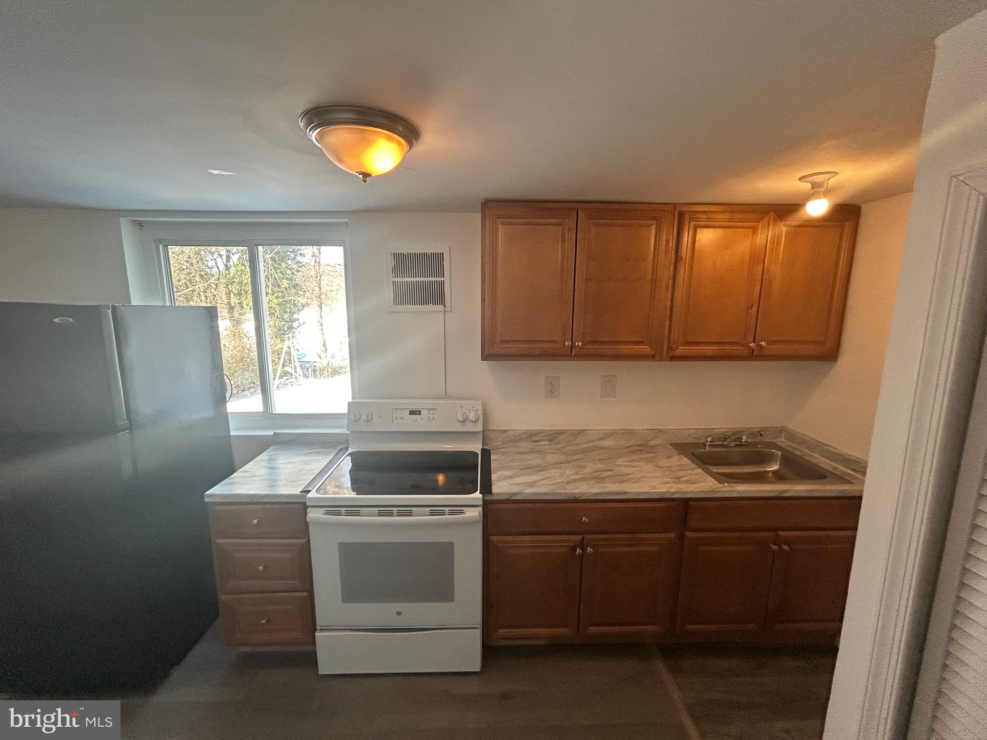 7208 Powhatan Street Lanham, MD 20706 - Photo 23 of 28 a kitchen with a sink stove and cabinets