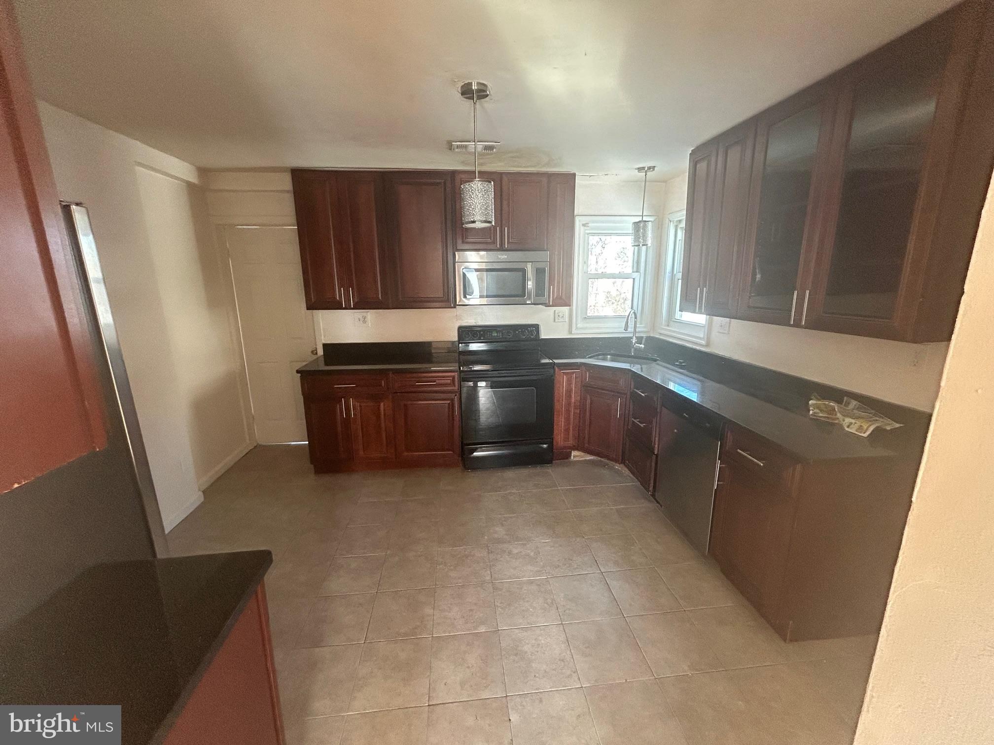 7208 Powhatan Street Lanham, MD 20706 - Photo 5 of 28 a large kitchen with stainless steel appliances granite countertop a sink stove and refrigerator