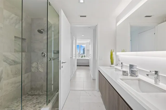 a bathroom with a sink double vanity and a mirror