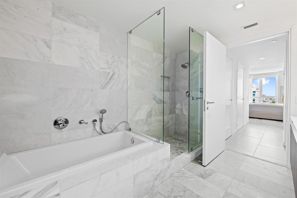 401 North Birch Road, Unit 903 Fort Lauderdale, FL 33304 - Photo 13 of 26 a spacious bathroom with a bathtub and shower