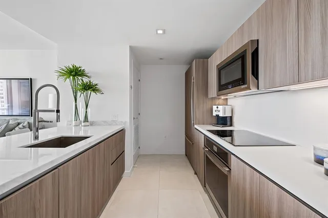 a kitchen with granite countertop a sink and a stove top oven