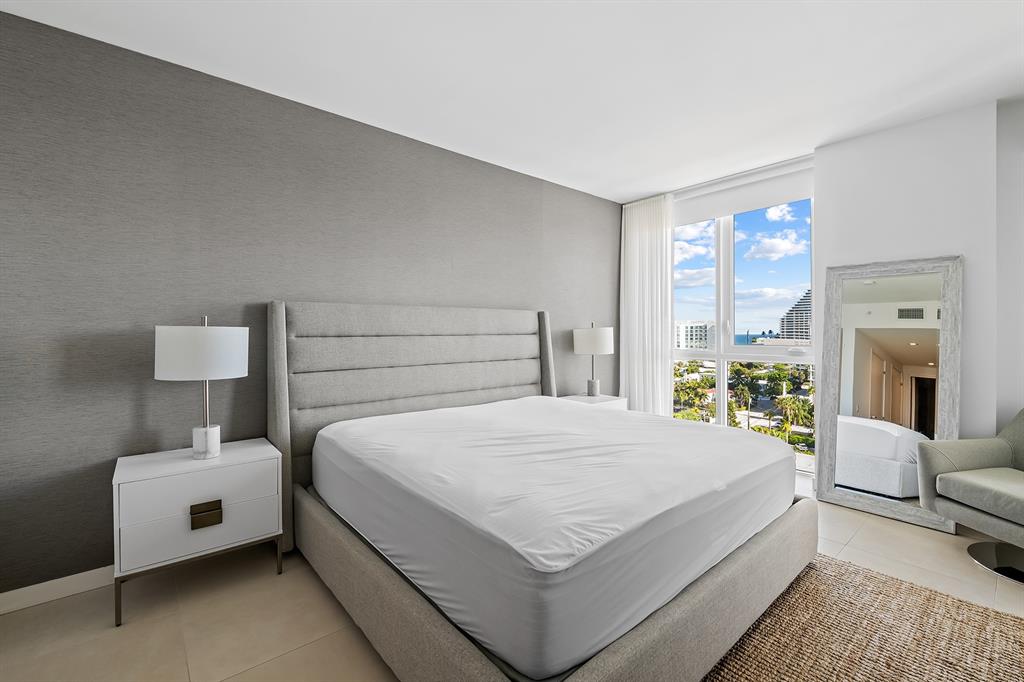 401 North Birch Road, Unit 903 Fort Lauderdale, FL 33304 - Photo 9 of 26 a bedroom with a bed and a couch