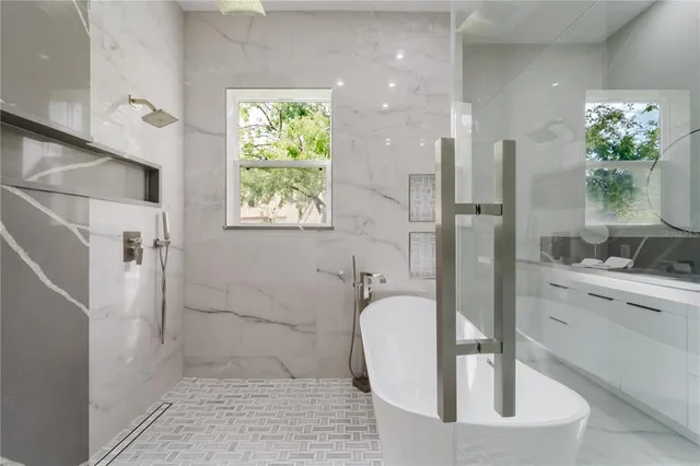 a bathroom with a granite countertop sink a toilet and shower