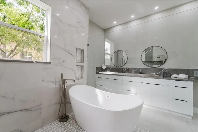 a white bath tub sitting next to a white sink