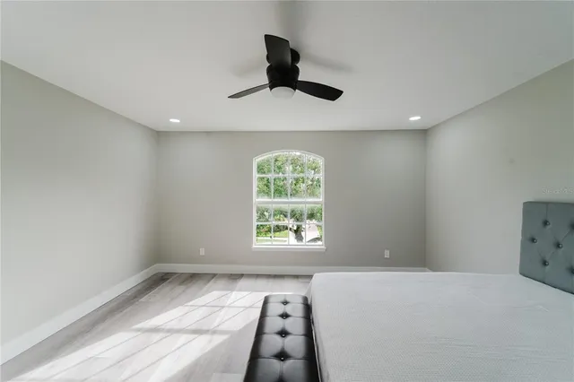 a bedroom with a large bed and a window