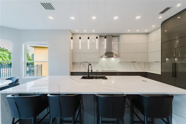 a kitchen with a table chairs sink and cabinets