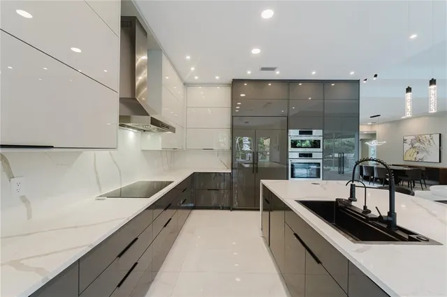 a kitchen with a sink a stove and chairs