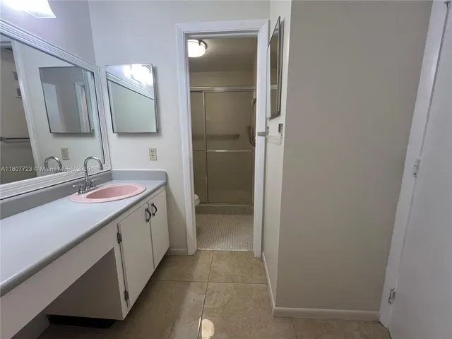 a bathroom with a double vanity sink mirror and double
