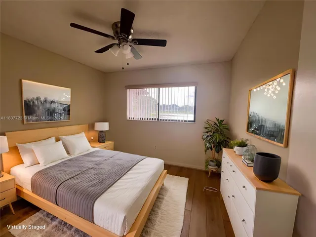 a spacious bedroom with a large bed and a flat screen tv