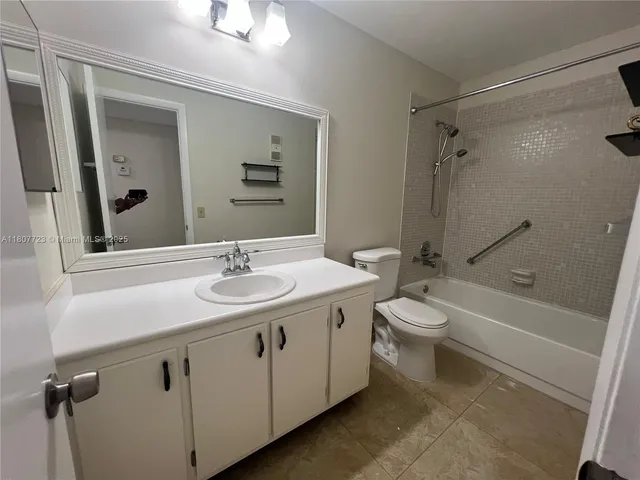 a bathroom with a double vanity sink toilet mirror and shower