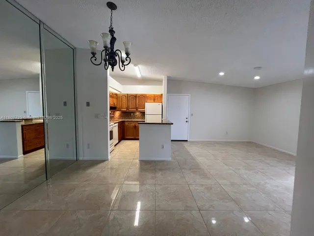 a view of a kitchen with a sink and cabinets