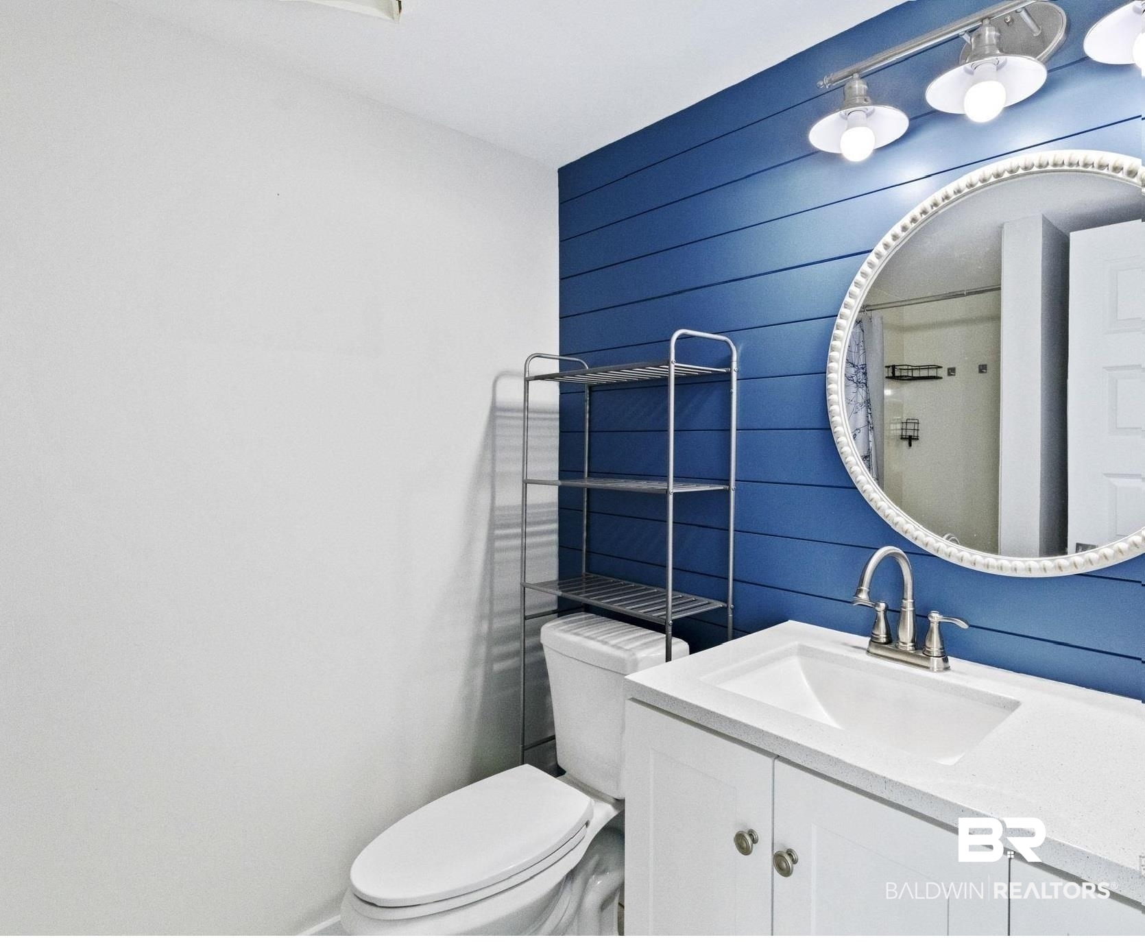 25861 Canal Road, Unit 77 Orange Beach, AL 36561 - Photo 25 of 48 Full bath featuring vanity, a shower with shower curtain, and wooden walls