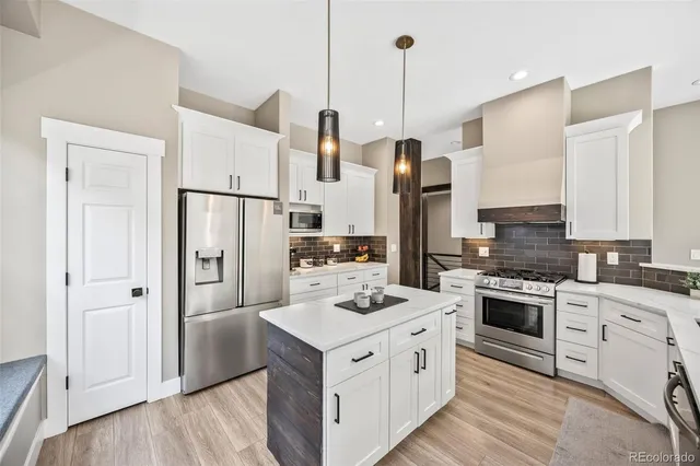 a stove top oven sitting inside of a kitchen