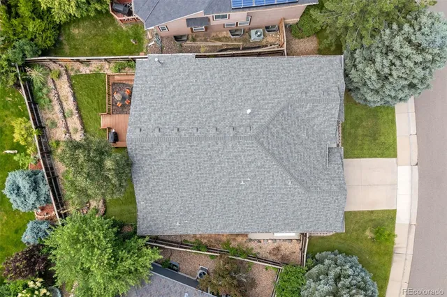 an aerial view of residential houses with outdoor space and swimming pool