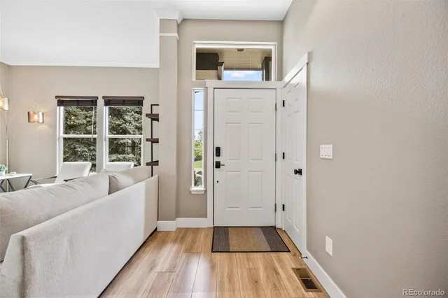 a living room with furniture and next to a window