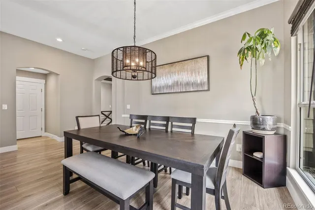 a view of a dining room with furniture wooden floor and chandelier