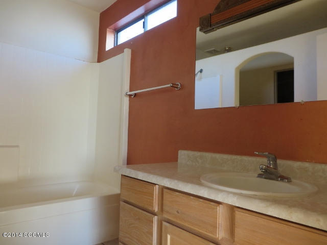 1255 Avenida Gloriosa Rio Rico, AZ 85648 - Photo 22 of 33 a bathroom with a sink and a mirror