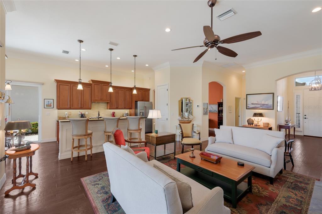5011 Tobermory Way Bradenton, FL 34211 - Photo 10 of 77 a living room with furniture kitchen view and a chandelier