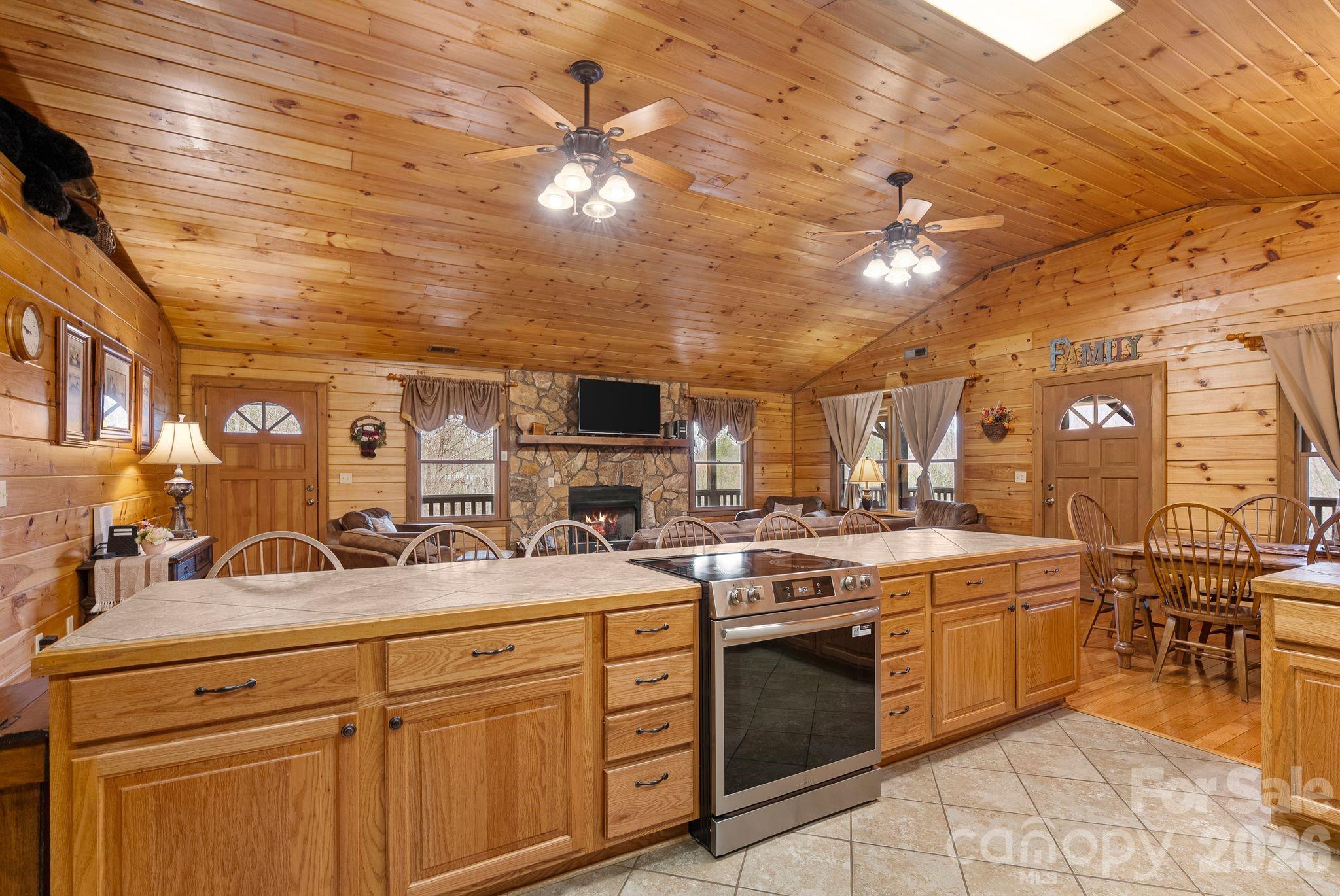 264 Moonbeam Lane Clyde, NC 28721 - Photo 11 of 46 a kitchen with a sink stove and cabinets
