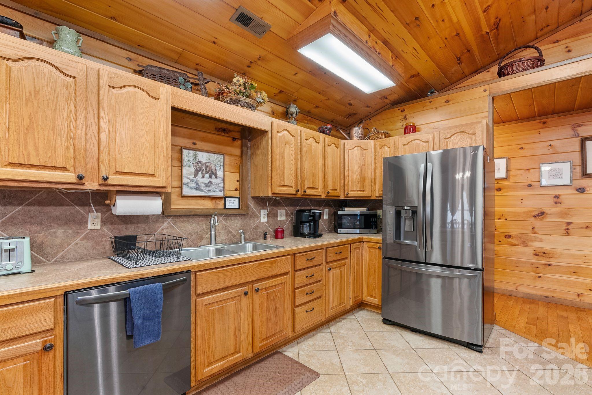 264 Moonbeam Lane Clyde, NC 28721 - Photo 12 of 46 a kitchen with stainless steel appliances a refrigerator and a sink