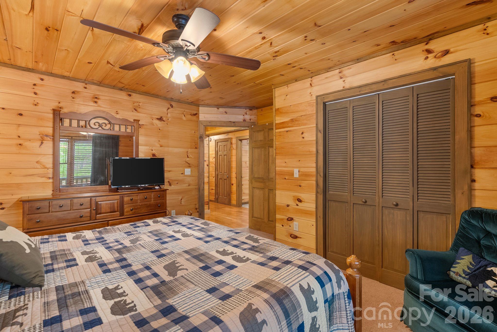 264 Moonbeam Lane Clyde, NC 28721 - Photo 14 of 46 a bedroom with a bed and a flat screen tv