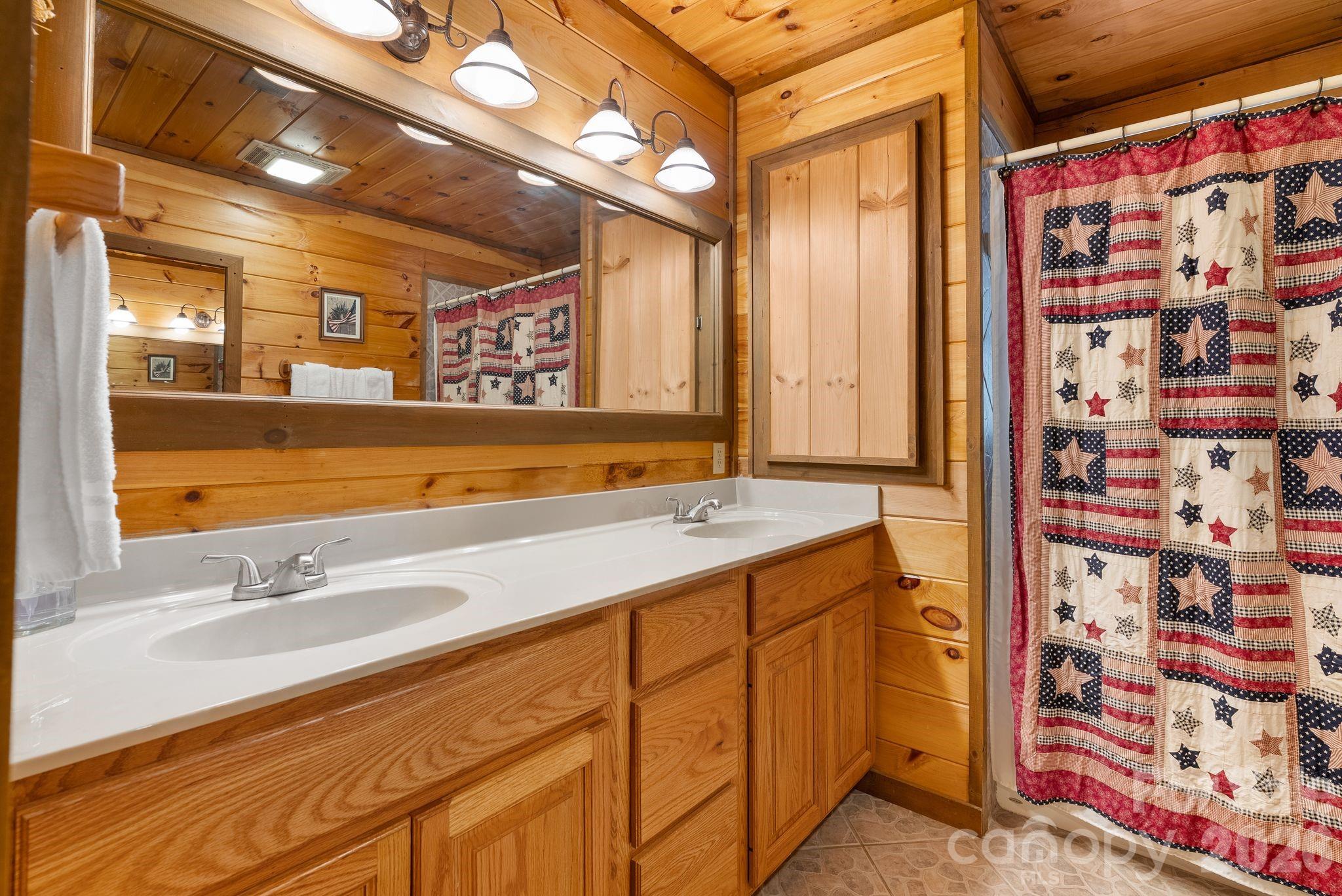 264 Moonbeam Lane Clyde, NC 28721 - Photo 19 of 46 a bathroom with a sink and a mirror
