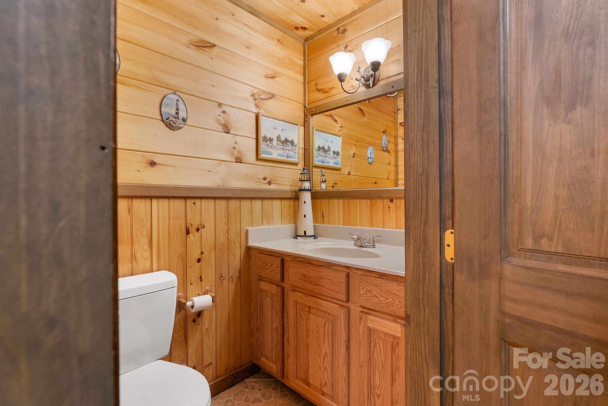 264 Moonbeam Lane Clyde, NC 28721 - Photo 21 of 46 a bathroom with a toilet sink and mirror