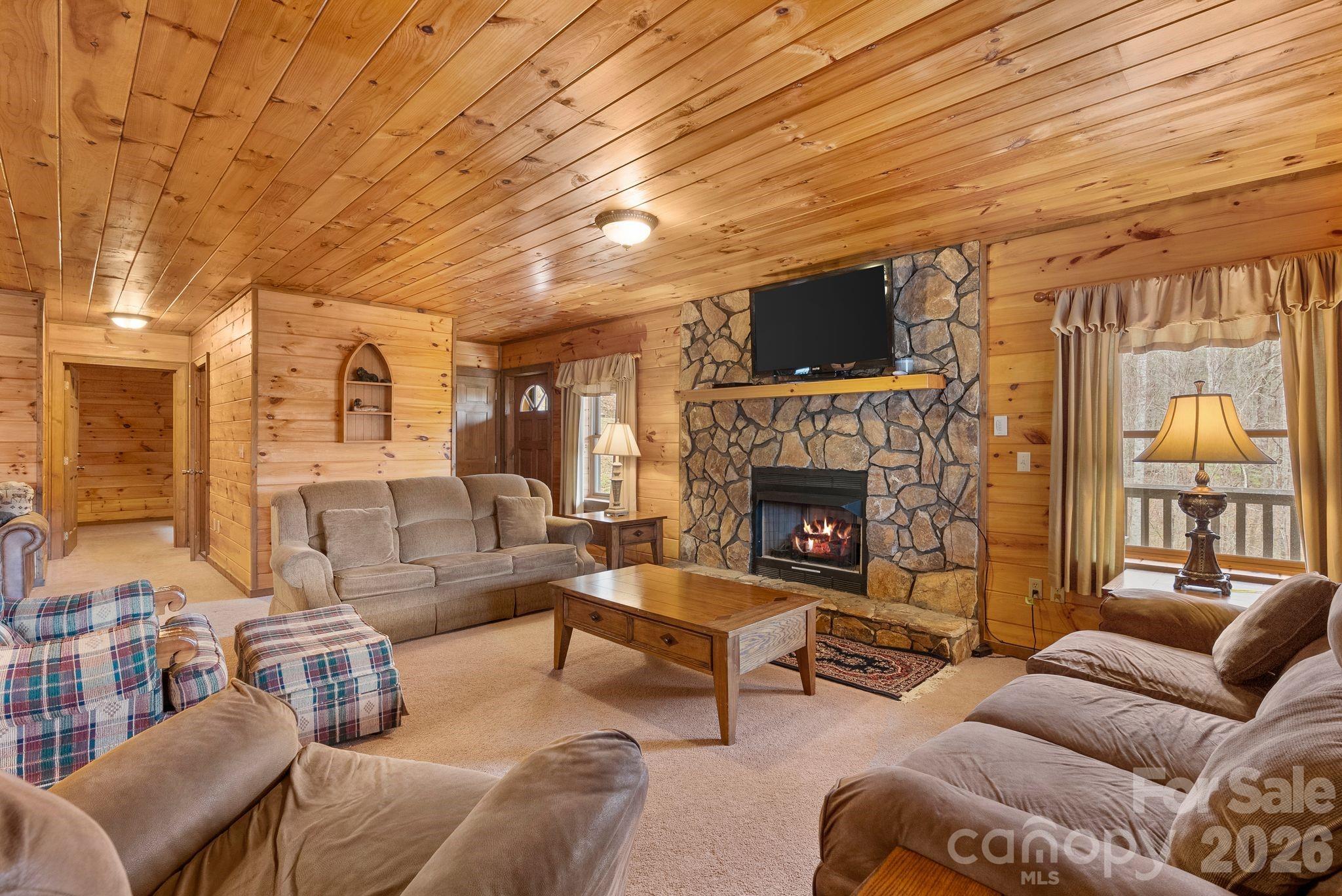 264 Moonbeam Lane Clyde, NC 28721 - Photo 24 of 46 a living room with furniture and a fireplace