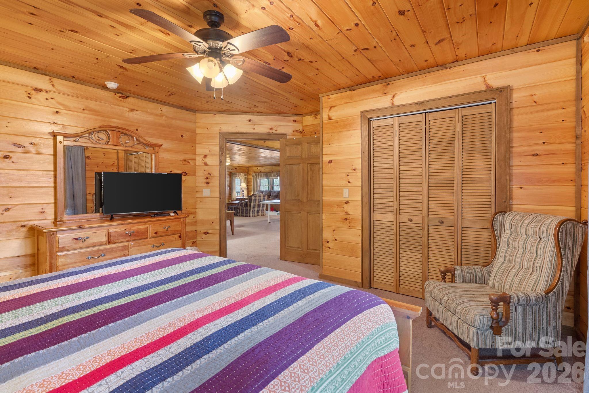 264 Moonbeam Lane Clyde, NC 28721 - Photo 29 of 46 a bedroom with a bed and a flat screen tv