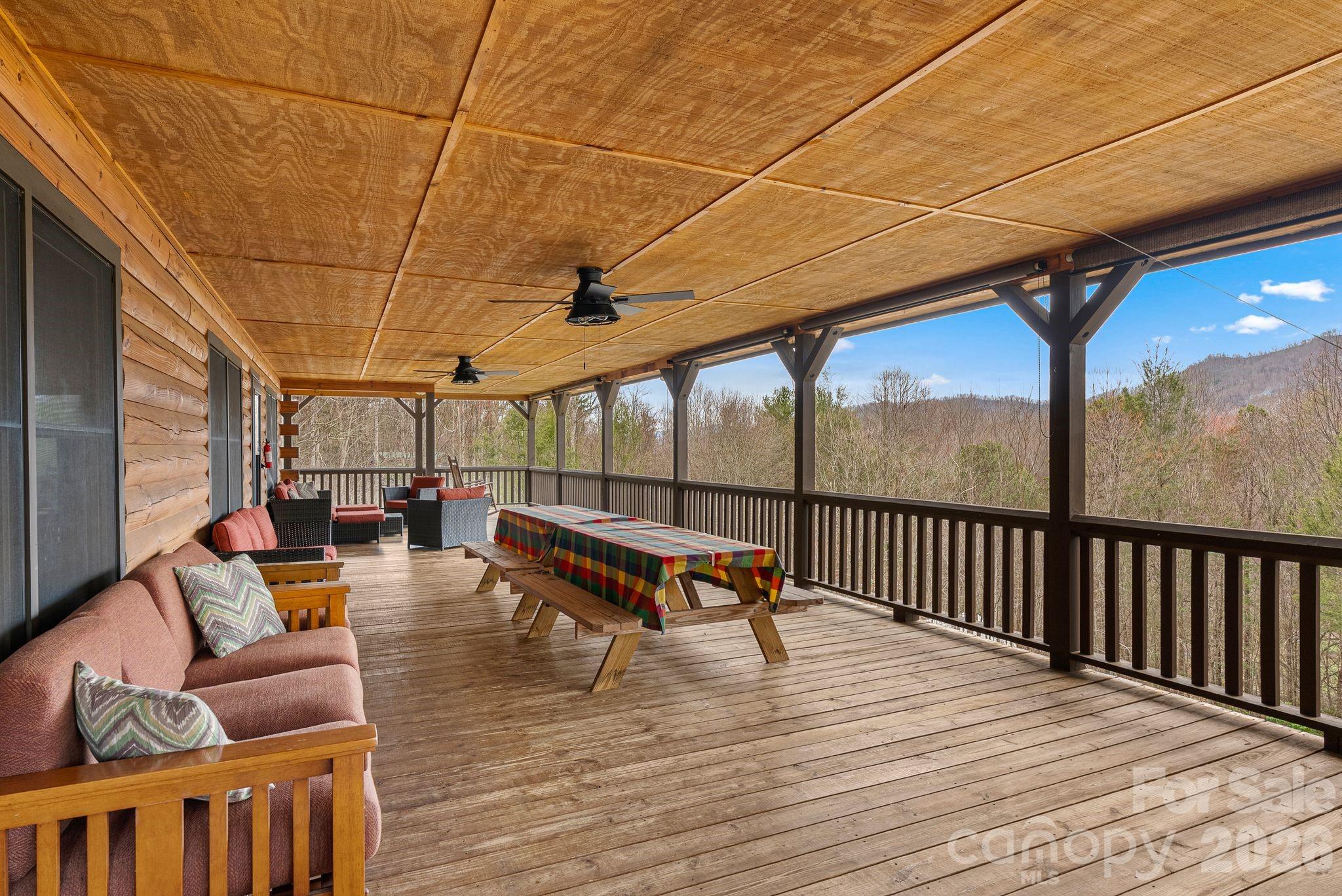 264 Moonbeam Lane Clyde, NC 28721 - Photo 35 of 46 a roof deck with a table and chairs