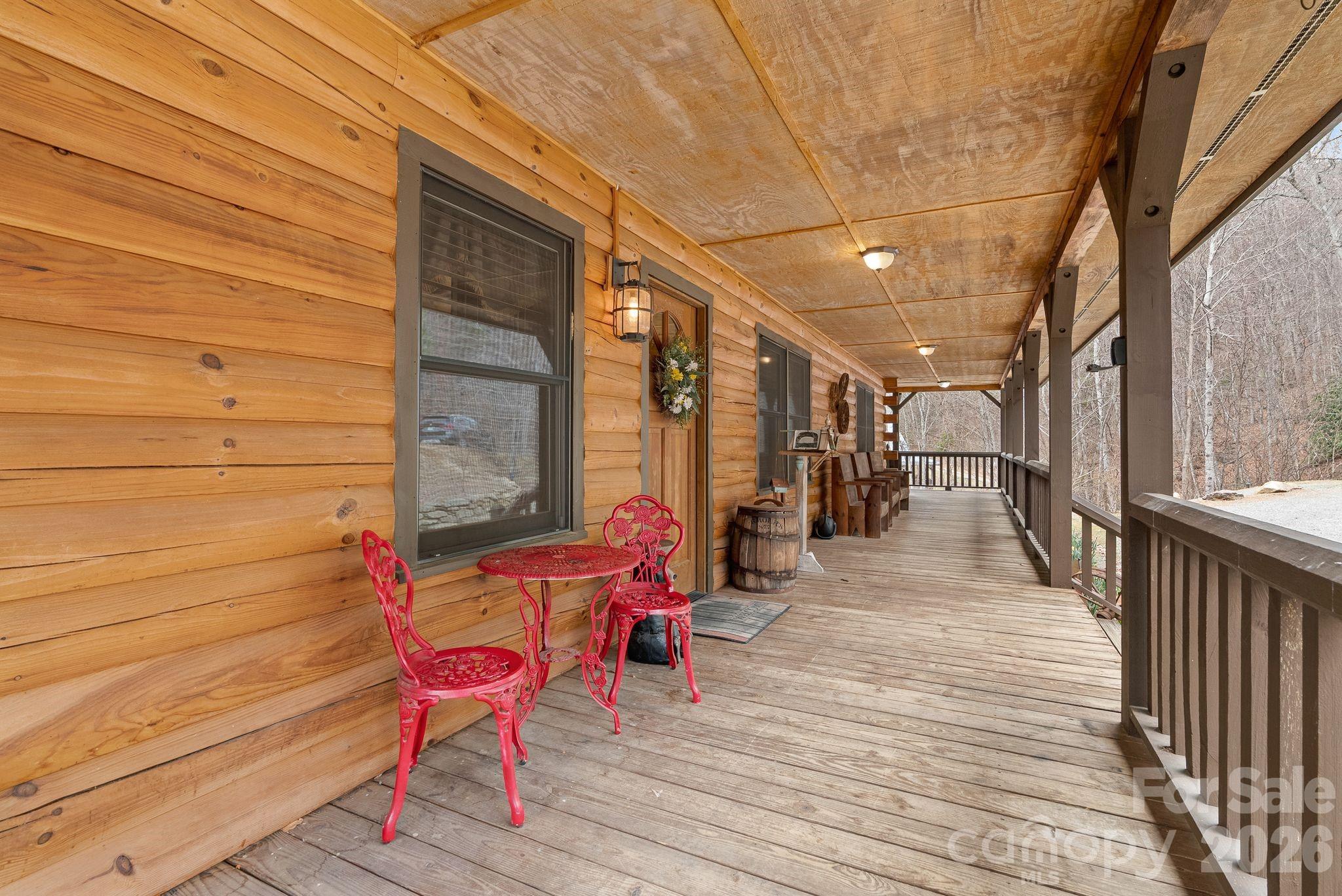 264 Moonbeam Lane Clyde, NC 28721 - Photo 4 of 46 a balcony with chairs and wooden floor