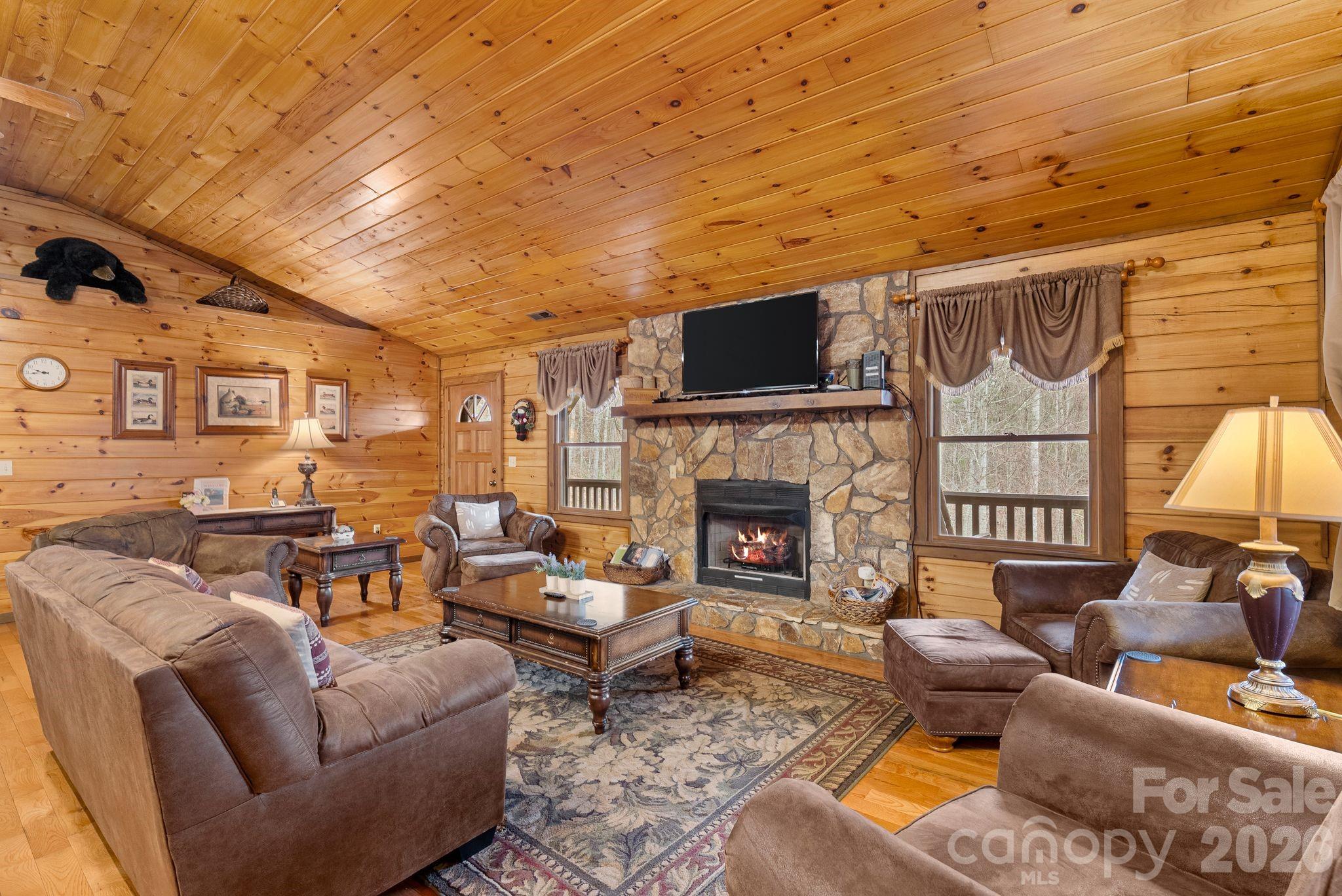 264 Moonbeam Lane Clyde, NC 28721 - Photo 5 of 46 a living room with furniture a fireplace and a flat screen tv