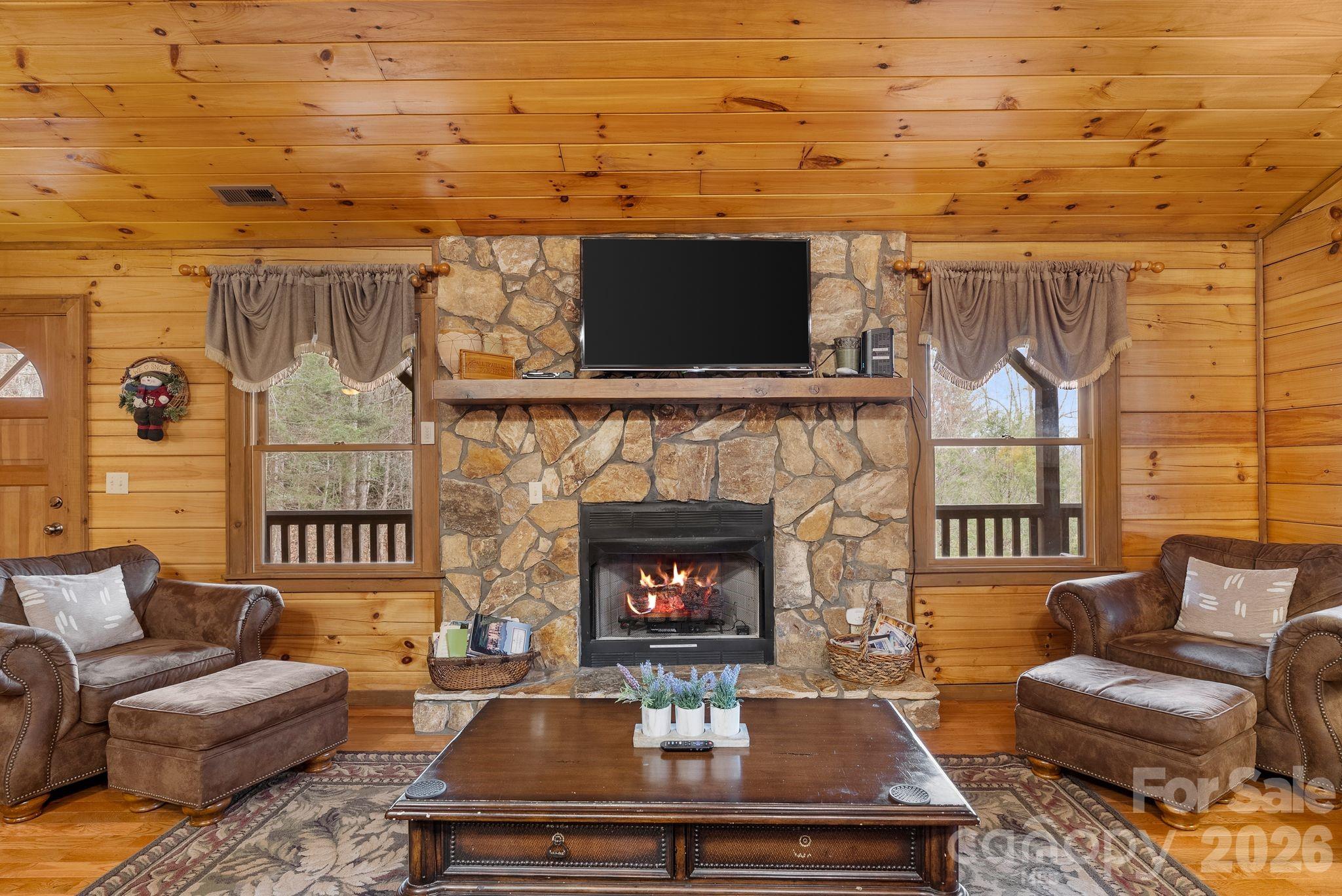 264 Moonbeam Lane Clyde, NC 28721 - Photo 7 of 46 a living room with furniture and a fireplace