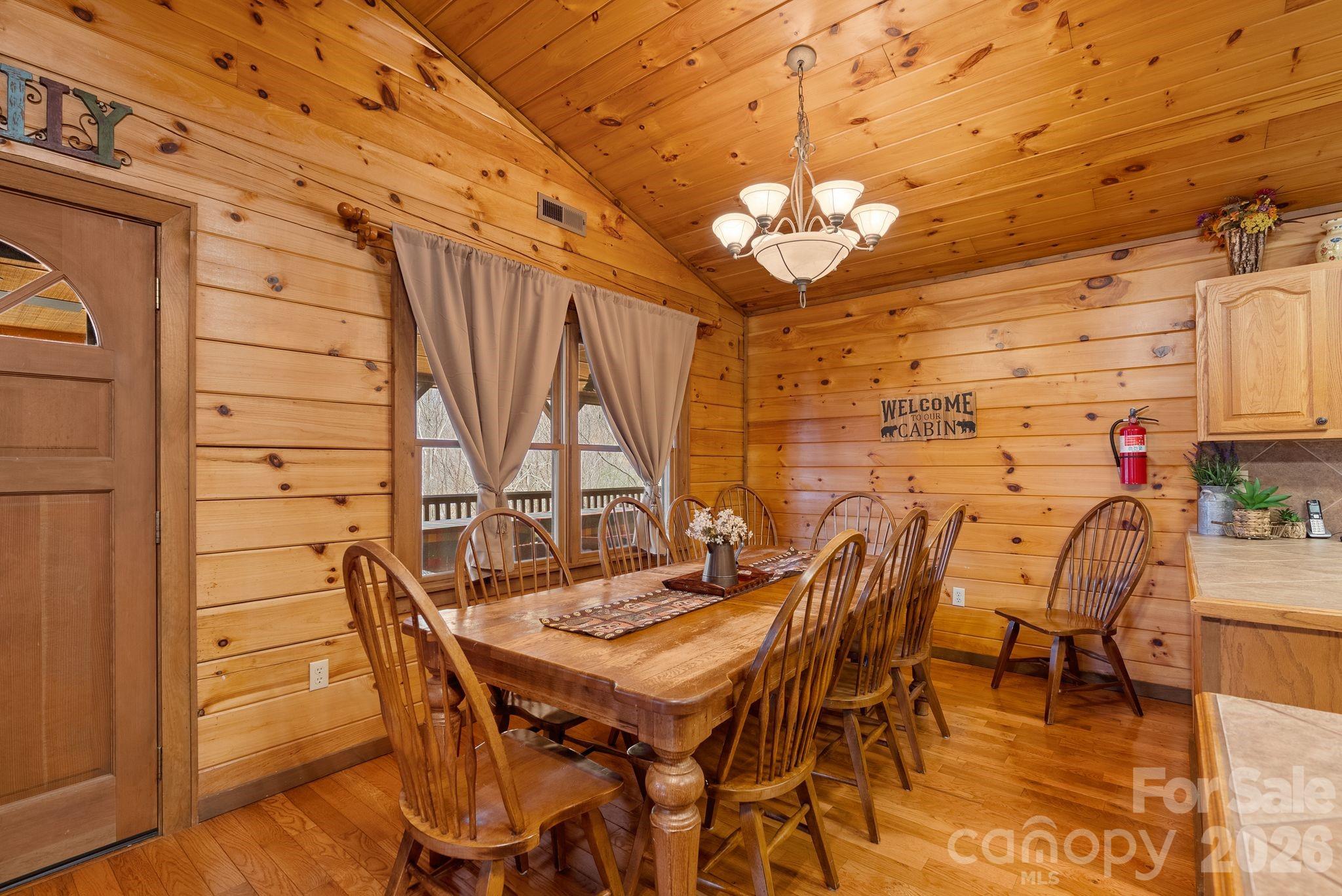 264 Moonbeam Lane Clyde, NC 28721 - Photo 9 of 46 a view of a dining room with furniture and wooden floor
