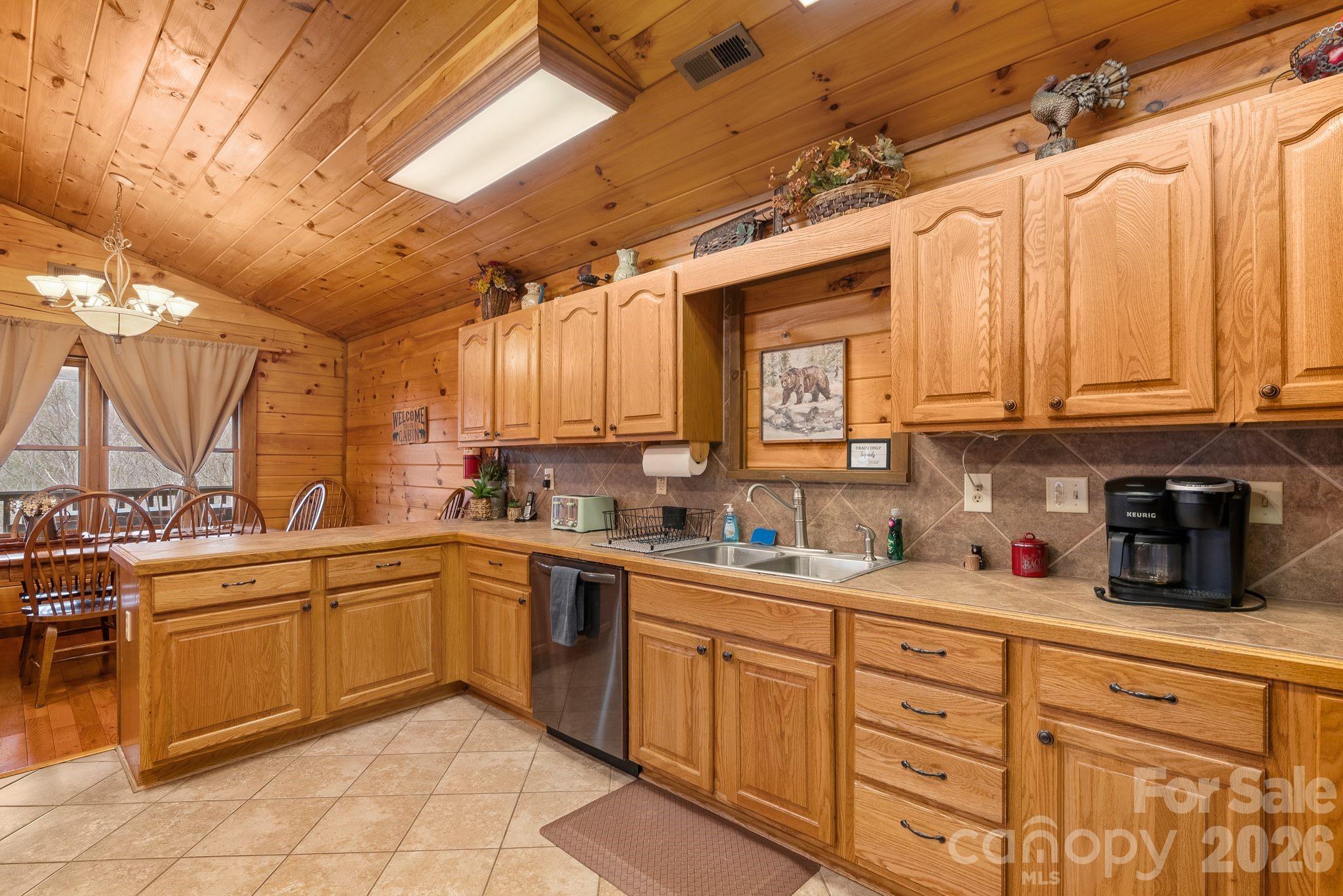 264 Moonbeam Lane Clyde, NC 28721 - Photo 10 of 46 a kitchen with a sink and cabinets
